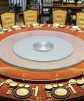 Rock Solid Tempered Glass Lazy Susan Rotating Serving Tray King Size on a dining table with set plates and glasses.