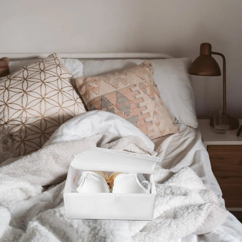 Premium Collapsible Oxford Cloth Drawer Organizer With Lid For Underwear Bras And Bathing Suits shown on a bed with decorative pillows.