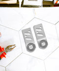 Heavy Duty Stainless Steel Sliding Door Rollers 4 Pack Featuring Precision Ball Bearings 23mm Axle on tiled surface with pliers.
