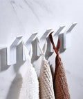 Heavy Duty Punch Free Wall Mounted Coat Hooks Premium Aluminum Alloy Build No Hassle Sticky Mount holding towels on a wall.