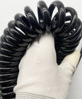 Tough As Nails Coiled Extension Cord With 6 Meter Extra Reach, Heavy Duty 4 Core Pure Copper Spiral Power Cable in hand.