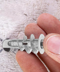Close-up of Heavy Duty Drywall Anchor Kit With Screws, 20 Sets, Self Drilling Zinc Alloy And Iron in hand, highlighted texture