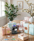 Bluetooth Portable Label Printer For Small Biz Fast Thermal Label Maker For Barcodes Addresses Clothing Pricing Mail Jewelry Cables And More Works With Phone And PC, shown on a table with labeled gift boxes.