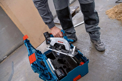 Badass 18V Cordless Brushless Circular Saw With Slick Six Point Five Inch Blade shown in protective case on construction site.