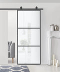 Super Slick Frosted Privacy Glass Barn Door Hardware Kit With Heavy Duty Track And Silent Rolling Wheels For Easy 36 By 84 Inch Sliding Install Plus Smooth Gliding Action Room Divider Setup displayed in a modern living space.