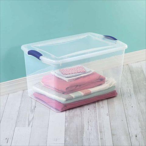 Heavy Duty SixtySix Quart Clear Plastic Storage Bins Two Pack With Blue Latch Lids Stackable Organizers For Bulky Seasonal Apparel And Sports Gear Easy Stash with folded blankets inside.