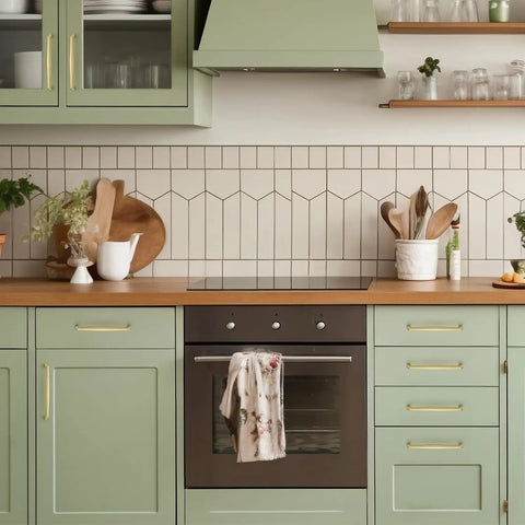 Kickass Brushed Gold Cabinet Handles And Drawer Pulls Made From Solid Zinc Alloy Heavy Duty Build Smooth Finish And No Drama Installation For Kitchens In Six Quarter Inch Pack Of Twenty Pieces shown on green kitchen cabinetry.