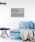Custom Printed Canvas Bulletin Board With Graphite Grey Bold Stripe Design, 30 By 20 Inches, Framed In Satin White Frame, above chair