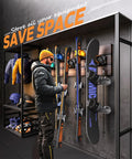 Man retrieving skis from a Badass Ski And Snowboard Wall Rack for space-saving garage storage with rubber pads.