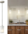 One Light Mini Pendant With White Frosted Shade, Brushed Nickel Finish over kitchen island, adjustable height cord, pack of 2