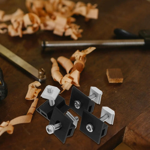 Premium 4 Piece Solar Panel Middle Clamps With M8 Bolts And Heavy Duty Pressure Blocks on a workbench with wood shavings.