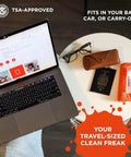Refillable Screen Cleaner Kit With Microfiber Cloth For MacBook, iPhone, iPad And Eyeglasses next to laptop and travel items