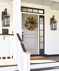Rock Solid Aluminum Outdoor Wall Light Featuring Slick Water Ripple Glass Exterior Fixture And Helluva Tough Weatherproof Porch Sconce Plus Knockout Doorway Accent For Backyard Or Garage Entry mounted beside a front door.