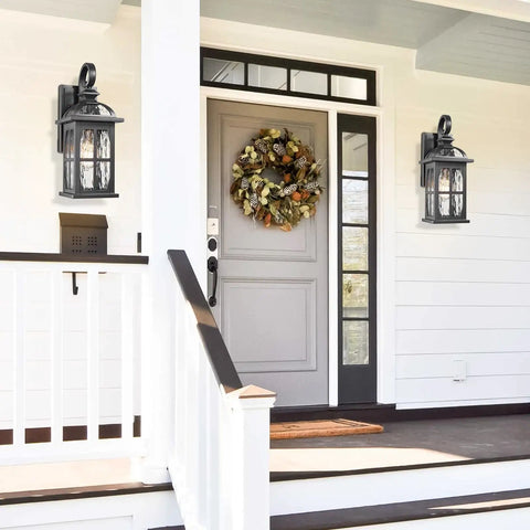 Rock Solid Aluminum Outdoor Wall Light Featuring Slick Water Ripple Glass Exterior Fixture And Helluva Tough Weatherproof Porch Sconce Plus Knockout Doorway Accent For Backyard Or Garage Entry mounted beside a front door.