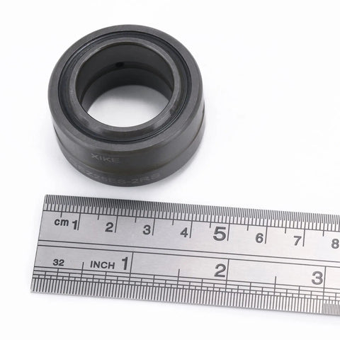 Solid GEZ25ES-2RS Sealed Radial Spherical Plain Bearing 1 Inch Bore chrome steel with ruler for size reference.