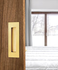 6 Inch Recessed Finger Flush Door Pulls For Pocket And Sliding Barn Doors In Brushed Gold Stainless Steel installed on wooden door
