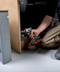 A professional using a Badass 18 Volt Cordless Brushless Drill Driver delivering 60 Newton Meters of torque for cabinet assembly.