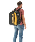 Massive 40 Liter Tool Backpack Built Tough As Nails For Contractors carried by a man, showcasing padded straps and durable material.