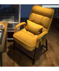 Comfortable yellow upholstered armchair with cushion, perfect for relaxation in a cozy workspace or living area.