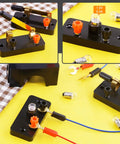 Badass 20 Piece Electrical Circuit Experiment Kit With Quick Attach Bulbs Dependable Switches And Heavy Duty Flexible Wiring on yellow surface.