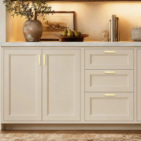 Heavy Duty Thirty Pack Cabinet Pulls And Kitchen Drawer Handles Cast In Rich Brushed Brass With A Precise Five Inch Spread, displayed on a kitchen cabinet.