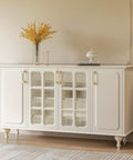 White cabinet with glass doors and gold cabinet pulls, featuring a brushed brass finish with safe rounded corners, in an elegant room.