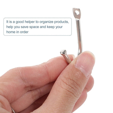 Thirty Pack Mini Iron Wall Hooks With Classic Silver Finish shown in hand, ideal for organizing coats and bags.