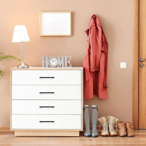White dresser with 3 Pack Black Cabinet Pulls 3.75 Inch Hole Center Wide Foot Drawer Pulls, next to a jacket and shoes.