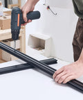 Person using a drill on Badass 2040 T-Slot Aluminum Extrusion Profile with sleek anodized finish for CNC projects.