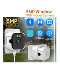 Hella Crisp 2K Cube Security Camera With Window Lens And Dual Band WiFi Live View AI Human Detection Full Color Night Vision Two Way Chat Built In Siren And 24 7 Loop Recording For Total Home Safe Vibes mounted on a wall with power cord.