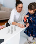 Mother and child assembling furniture with 10 Pack Iron Corner Brackets With 90 Degree Rounded Right Angle Heavy Duty L Shaped Shelf Braces.