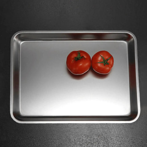 Heavy Duty Commercial 13 X 18 Half Size Aluminum Sheet Pan And Bun Tray With Sturdy Tapered Sides holding two tomatoes.