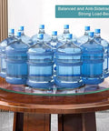 Heavy Duty Round Tempered Glass Lazy Susan With Swivel Assist Mechanism Hassle Free 360 Degree Rotation Serving Turntable displaying multiple water bottles.