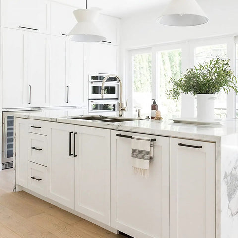Modern white kitchen with 30 pack 5 inch matte black cabinet pulls square stainless steel drawer handles for cabinets and drawers.