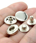 Premium Brass Metal Snap Buttons Fastener Kit With Heavy Duty Tools Silver 15mm showing various snap buttons held in hand.