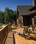 Outdoor wooden deck with chairs, built using PrimeGuard Plus Premium Deck Screws For Outdoor DIY Projects.