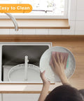 Person cleaning a 12 Inch 2 Tier Lazy Susan Turntable Organizer Adjustable Height Smooth Rotation Kitchen Countertop Spice Rack White.