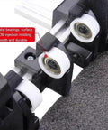 Close-up of heavy duty manual box folding tool for shipping cartons, showcasing metal bearings and smooth wheels for quick adjustment.