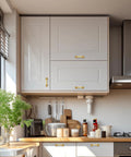 Top Notch Gold Cabinet Pulls For Modern Kitchens on sleek white cabinets in bright kitchen setting.