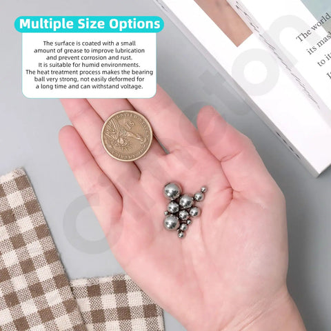 Heavy Duty Loose Bicycle Bearing Balls Assortment Kit With 300 Precision Steel Replacement Balls Across 12 Ready To Roll Sizes displayed in hand with coin.