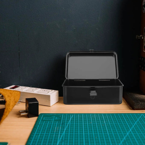 Small Iron Toolbox Featuring A Snug Metal Clasp For Portable Hand Carry Home Projects And Road Trip Trunk Organization on a wooden workbench.