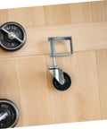 Badass 4 Inch Rubber Gate Wheel Caster Featuring An Adjustable Spring Bracket mounted on wood, designed for sliding gates.