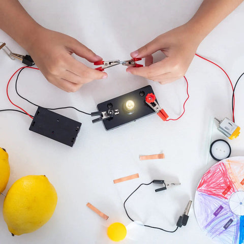 Hands connecting E10 Screw Base Miniature Bulbs, 24V 1.5W Warm Yellow Light for Your Flashlights and Indicators in a DIY setup.