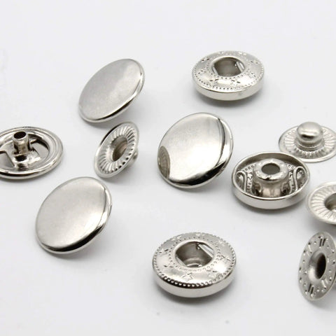 Premium Brass Metal Snap Buttons Fastener Kit With Heavy Duty Tools Silver 15mm showing assorted silver snap buttons for clothing repairs.