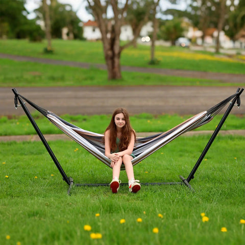 Double Hammock With Steel Stand Included 450Lb Capacity Portable Backyard Camping Garden Hammock With Premium Carry Bag And Anti Roll Balance Beams In Brown Stripes For Ultimate Outdoor Vibes installed on grass