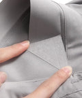 240 Pack Invisible Adhesive Shirt Collar Stays being placed inside a gray shirt collar for a crisp look.