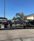 Vehicles secured with 4 Pack Beefed Up Heavy Duty 2 Inch By 10 Foot Wheel Straps With Flat Hooks on trailer for hauling