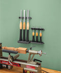Grab And Go Pro Grade Wall Mounted Tool Organizer with chisels over a woodworking lathe in a busy shop