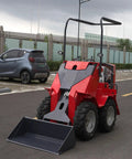 Versatile Mini Crawler Skid Steer Loader With Hydraulic Cylinder, parked on road, wear-resistant bucket, LED work light visible.