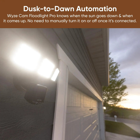 Floodlight Security Camera Pro With 2.5K HD Color Night Vision installed on a garage, dusk-to-dawn automation feature in use.